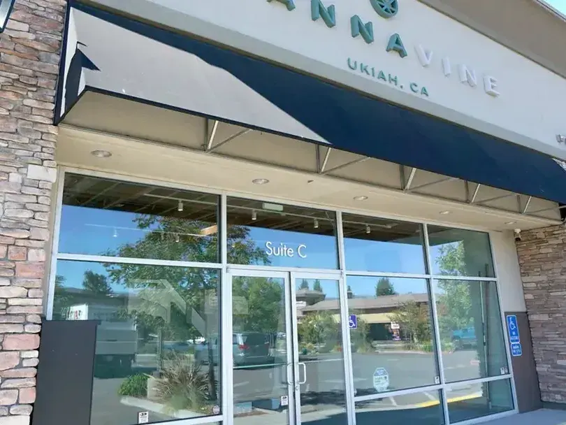 Cannavine Ukiah storefront with stone pillars, awning, and glass doors