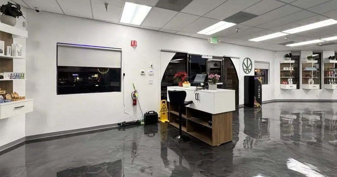 Spacious dispensary interior with polished floors, white walls, and product displays